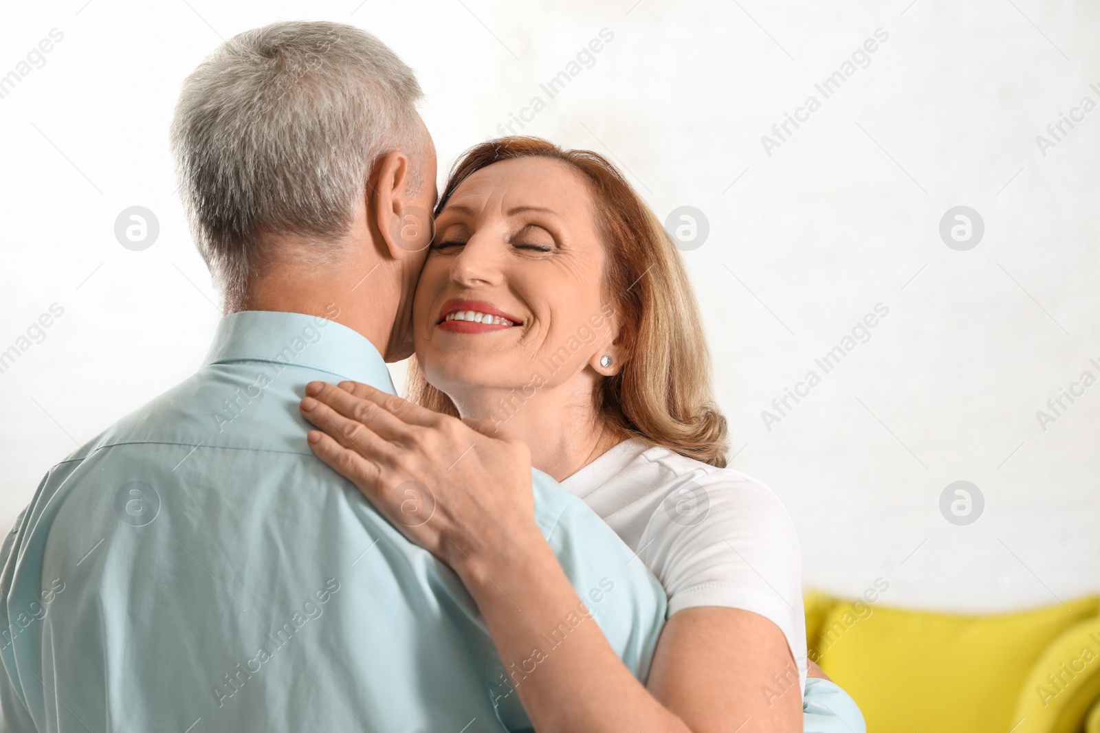 Photo of Happy senior couple dancing together at home