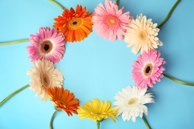 Flat lay composition with beautiful bright gerbera flowers on color background. Space for text