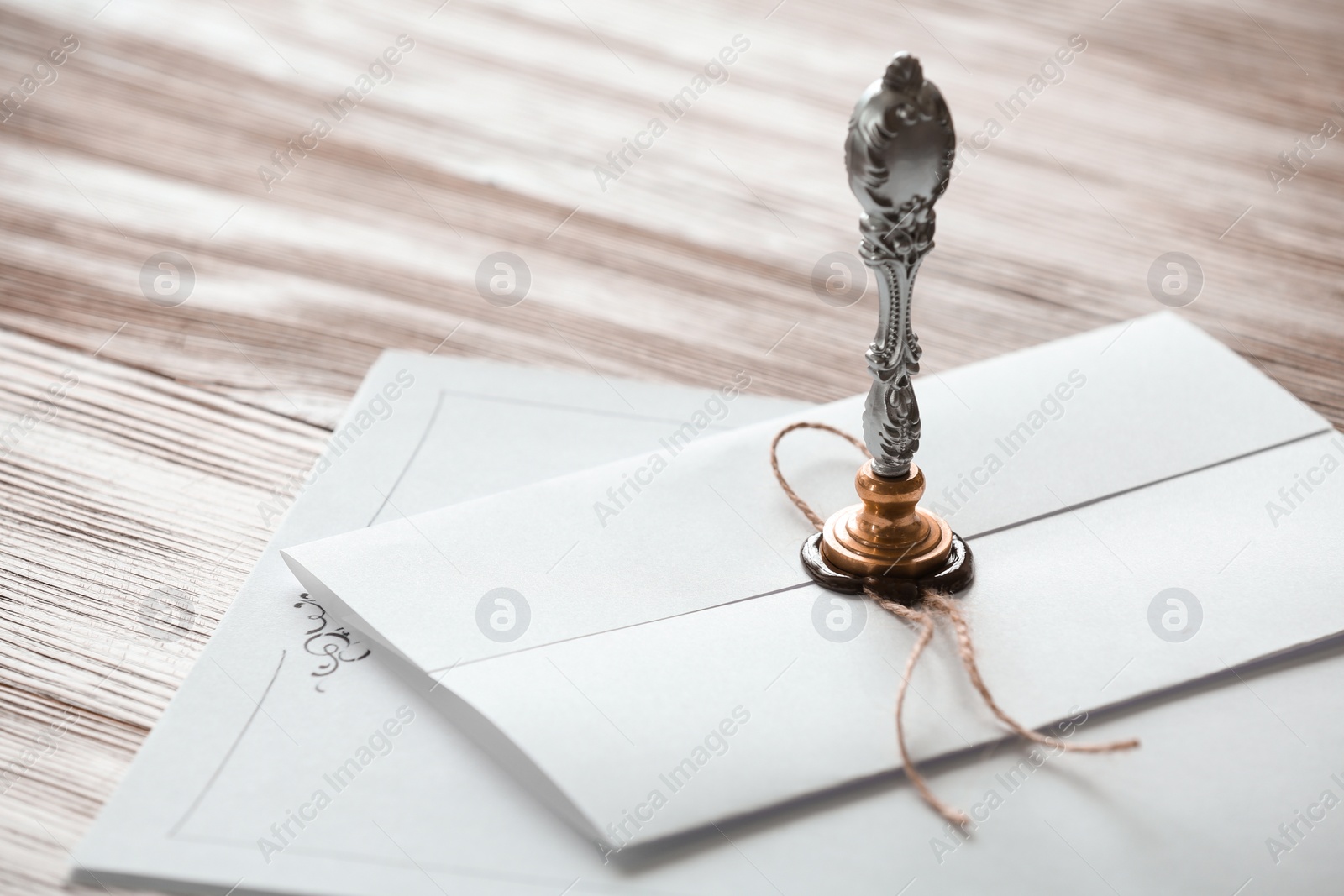 Photo of Vintage notary stamp and documents on wooden table, closeup. Space for text