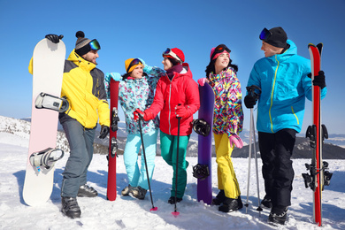 Group of friends with equipment at ski resort. Winter vacation