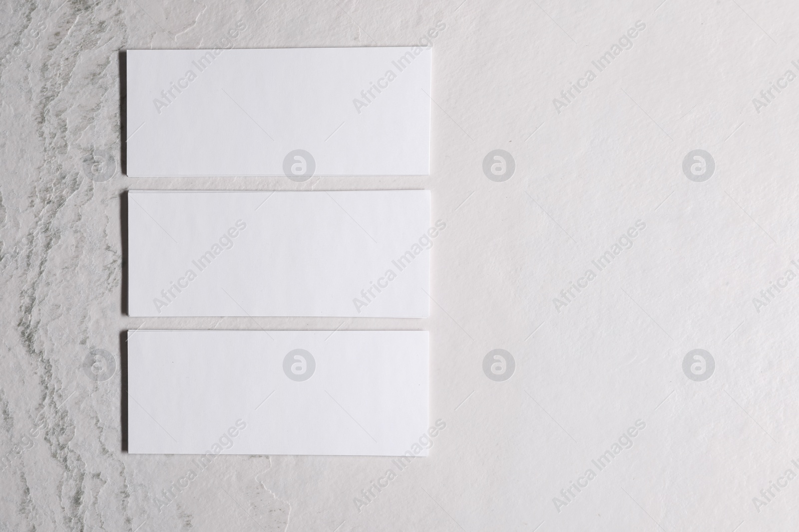 Photo of Blank business cards on beige textured background, top view. Mockup for design