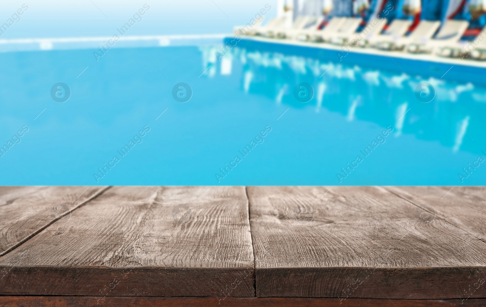 Image of Wooden deck near swimming pool outdoors on sunny day. Space for text