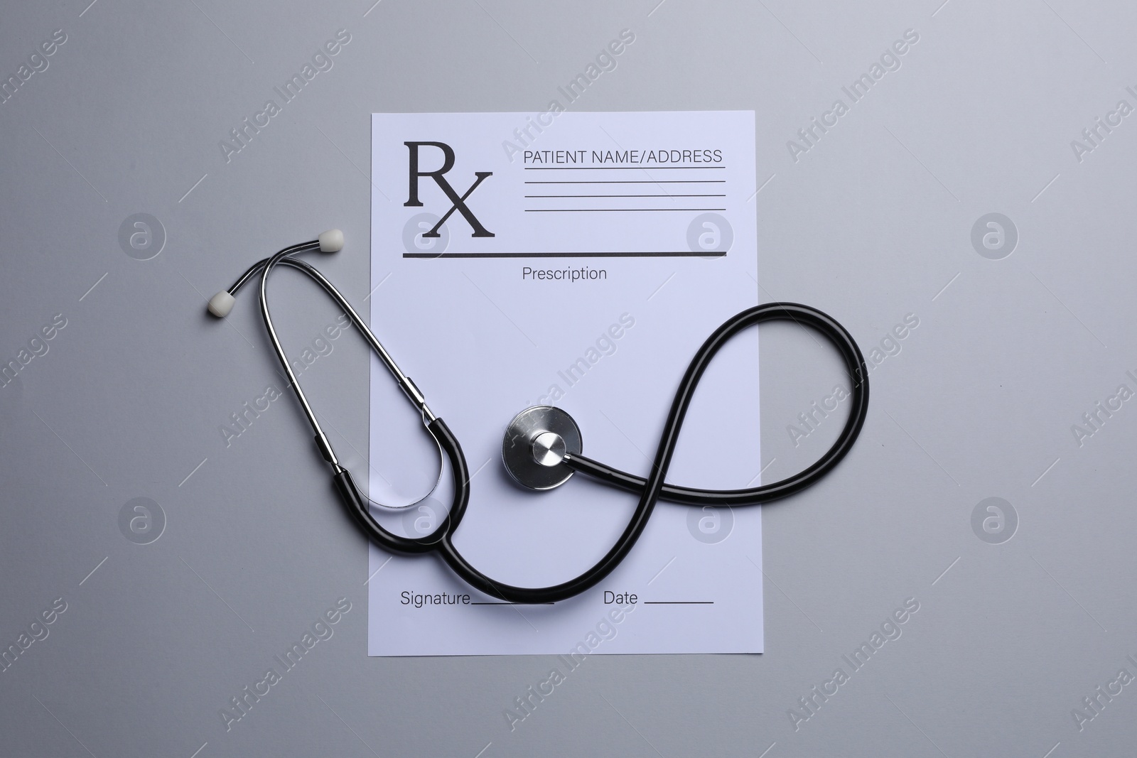 Photo of Medical prescription form and stethoscope on light grey background, flat lay