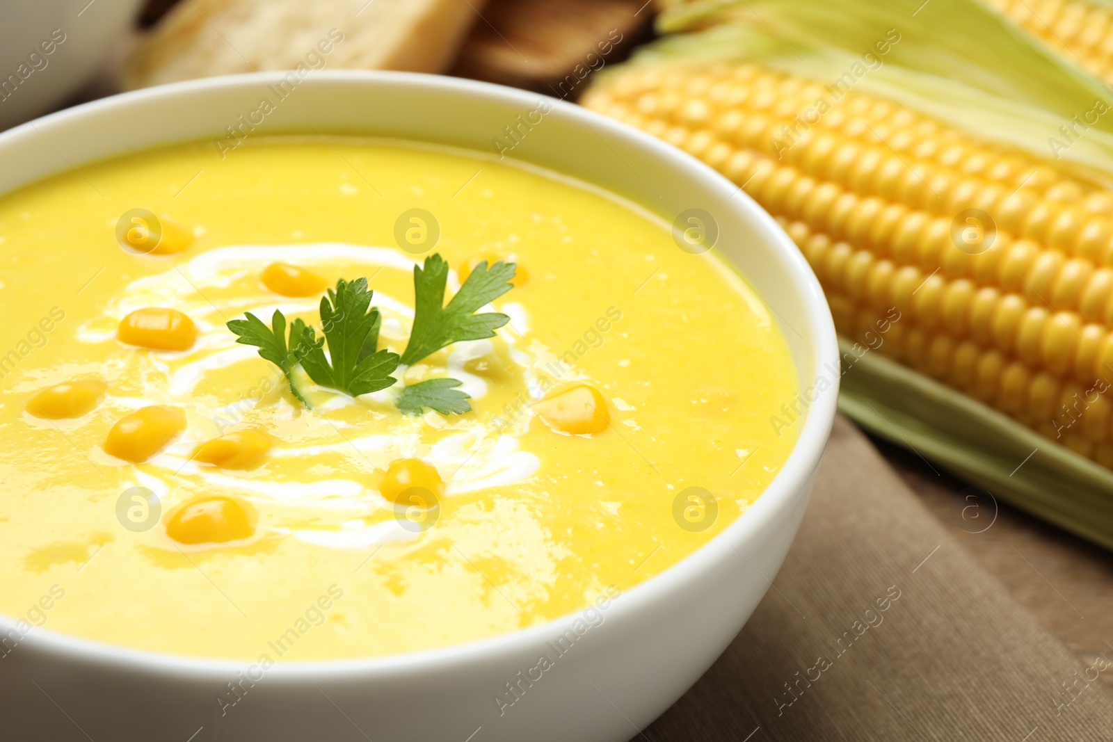 Photo of Delicious creamy corn soup in bowl, closeup