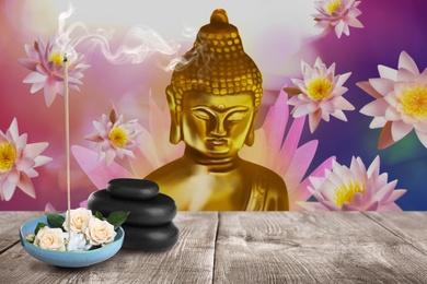 Image of Composition with smoldering incense stick on wooden table and Buddha figure on background. Space for text
