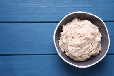 Photo of Delicious lard spread on blue wooden table, top view. Space for text