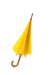 Photo of Modern closed yellow umbrella isolated on white