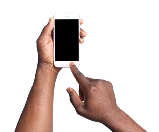 Photo of African-American man holding mobile phone with blank screen in hands on white background