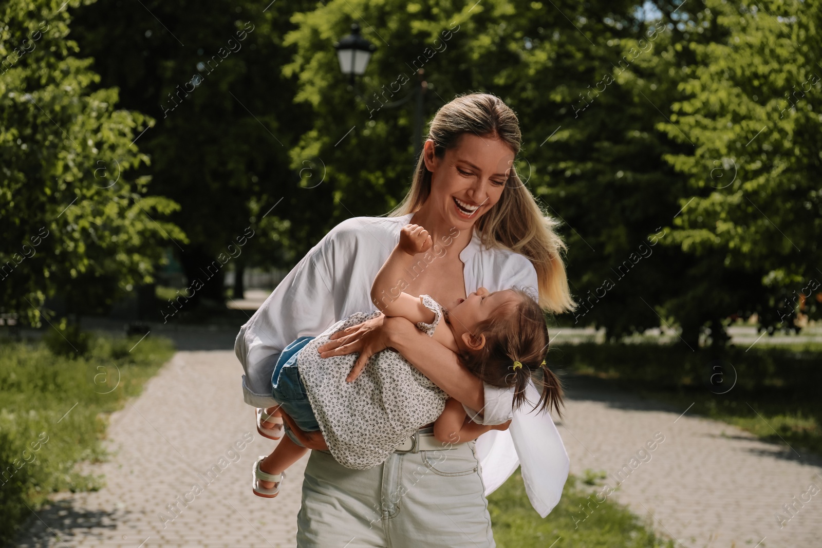 Photo of Happy mother with her daughter having fun in park