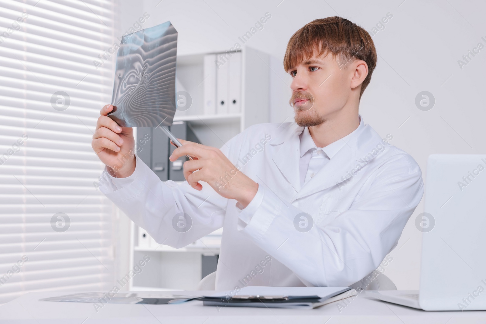 Photo of Doctor examining neck MRI image in clinic