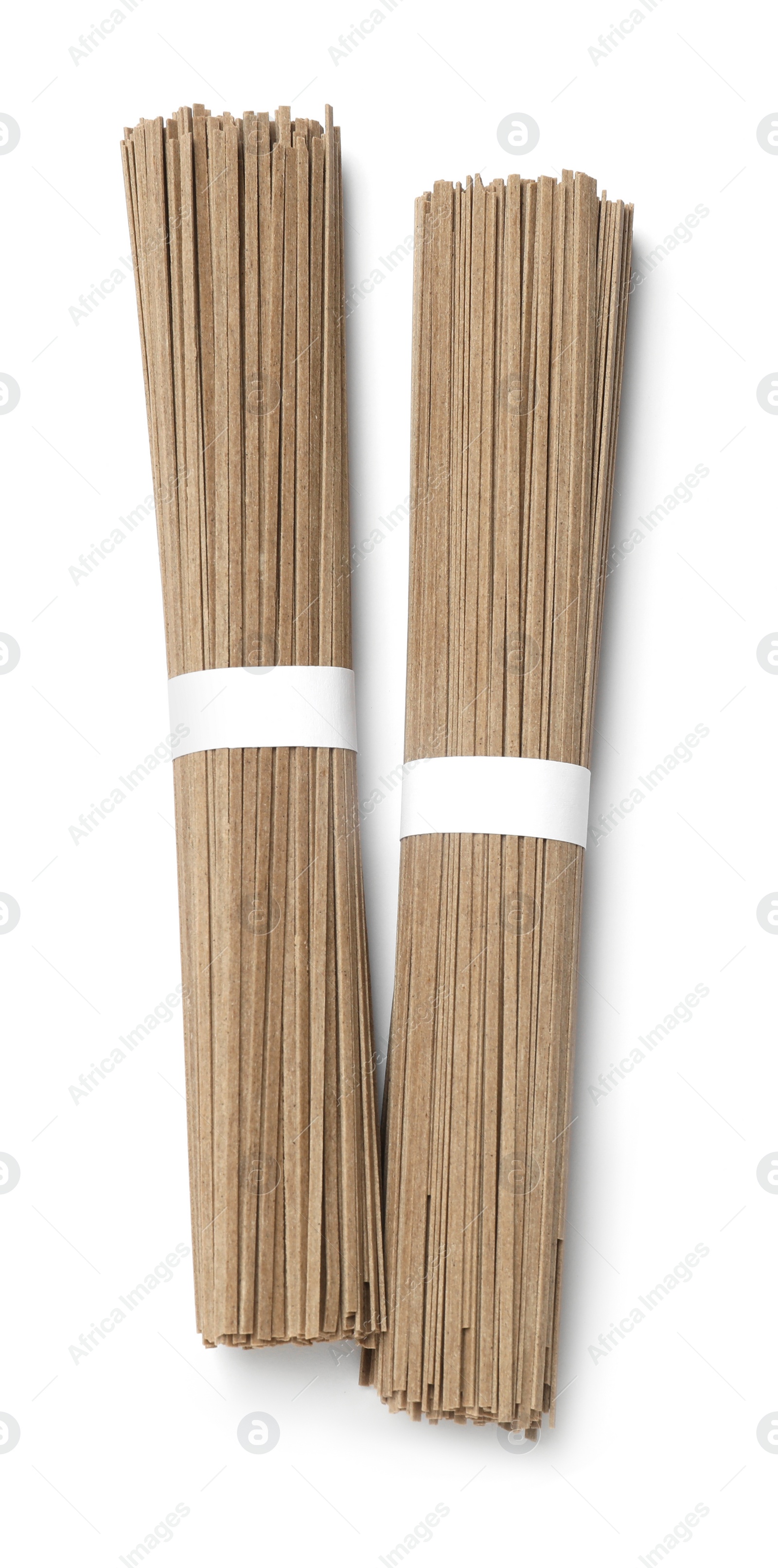 Photo of Uncooked buckwheat noodles (soba) isolated on white, top view