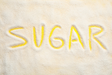 Photo of Composition with word SUGAR on yellow background, top view