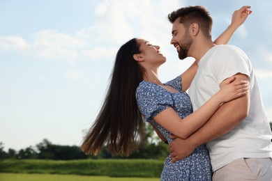 Photo of Romantic date. Beautiful couple spending time together outdoors, space for text