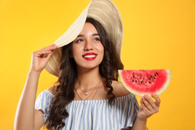 Photo of Beautiful young woman with watermelon on yellow background