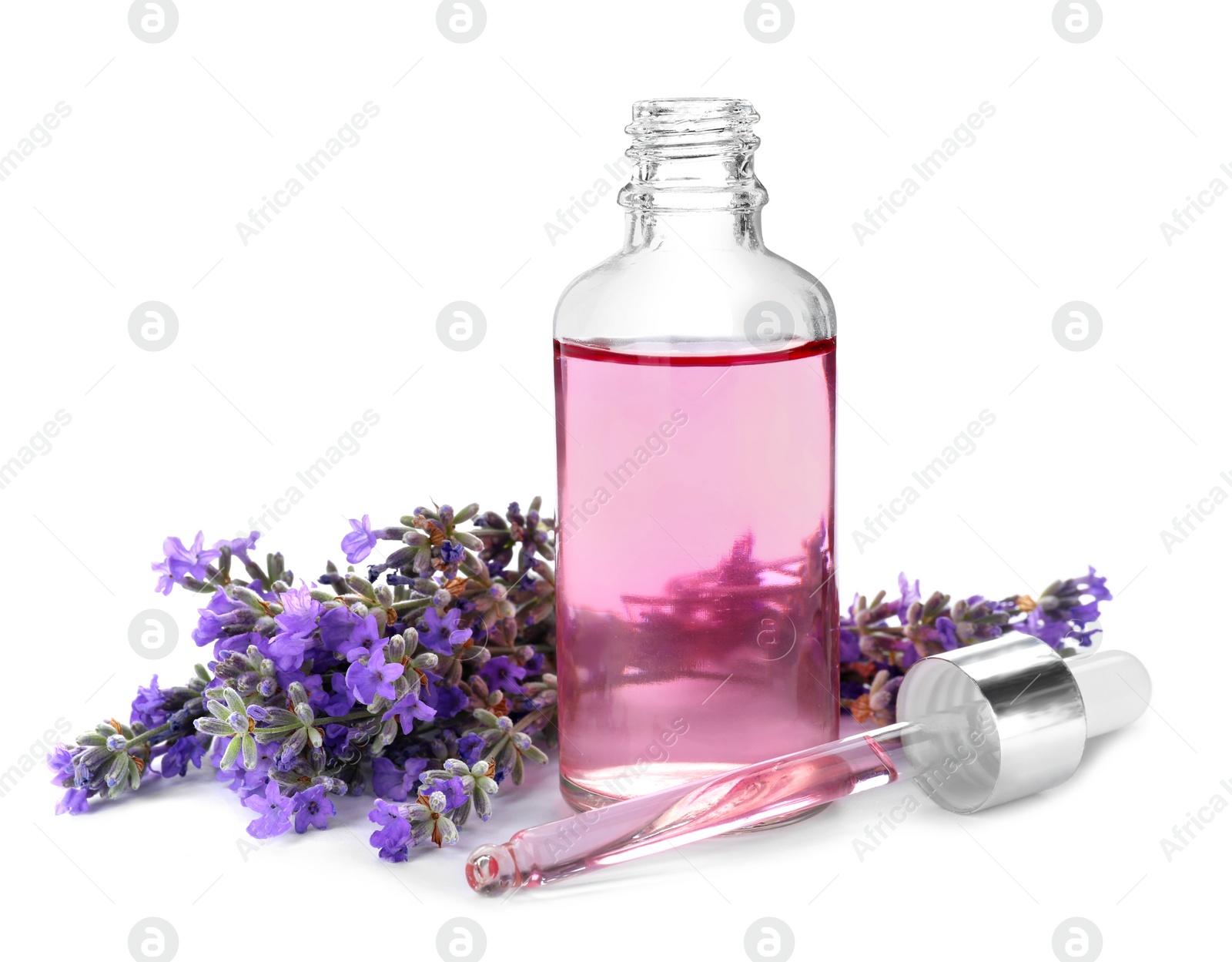 Photo of Bottle with natural lavender oil, flowers and dropper on white background