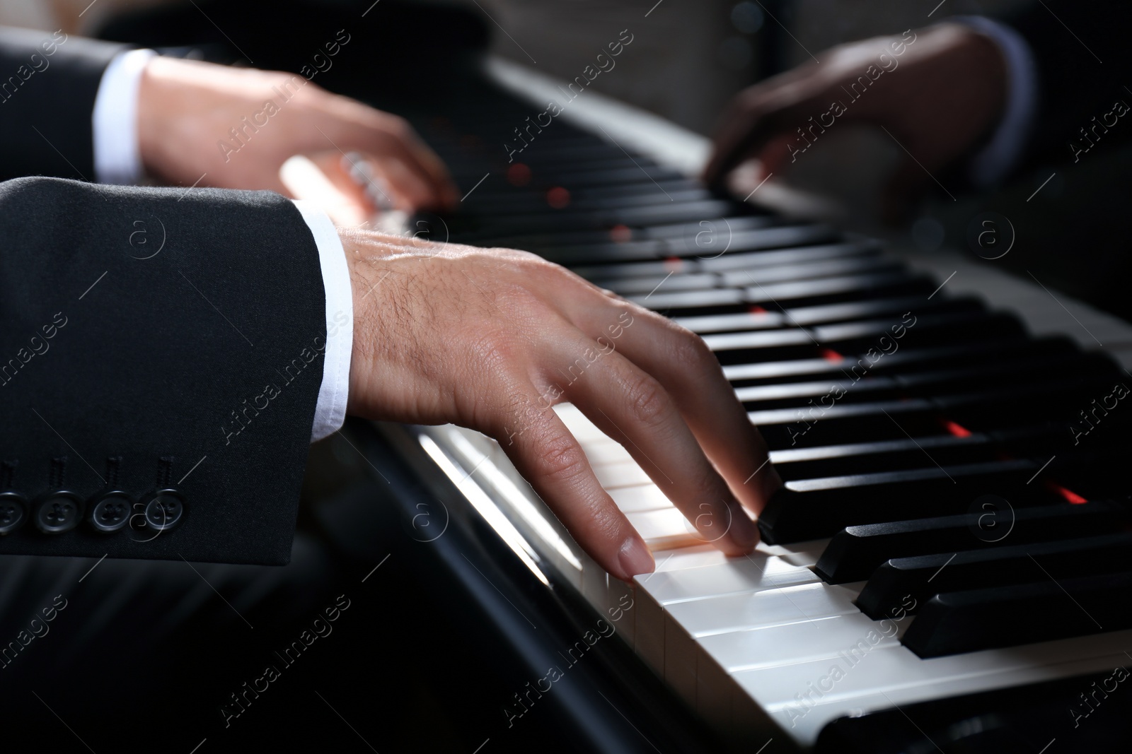 Photo of Man playing grand piano, closeup. Talented musician