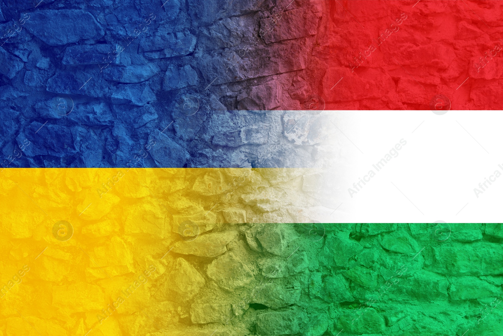 Image of Flags of Ukraine and Hungary on stone wall. International diplomatic relationships