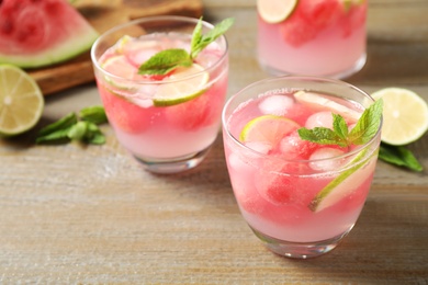 Photo of Tasty refreshing watermelon drink on wooden table