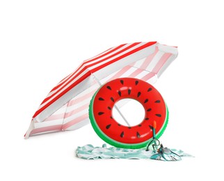Open striped beach umbrella, inflatable ring, blanket and diving equipment on white background