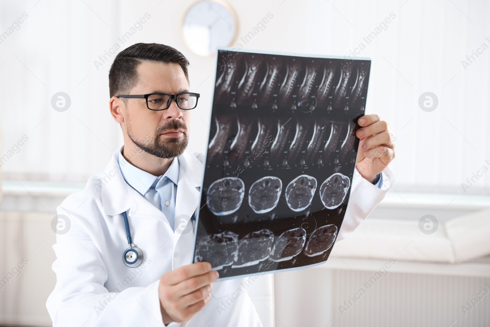 Photo of Professional orthopedist examining X-ray picture in clinic