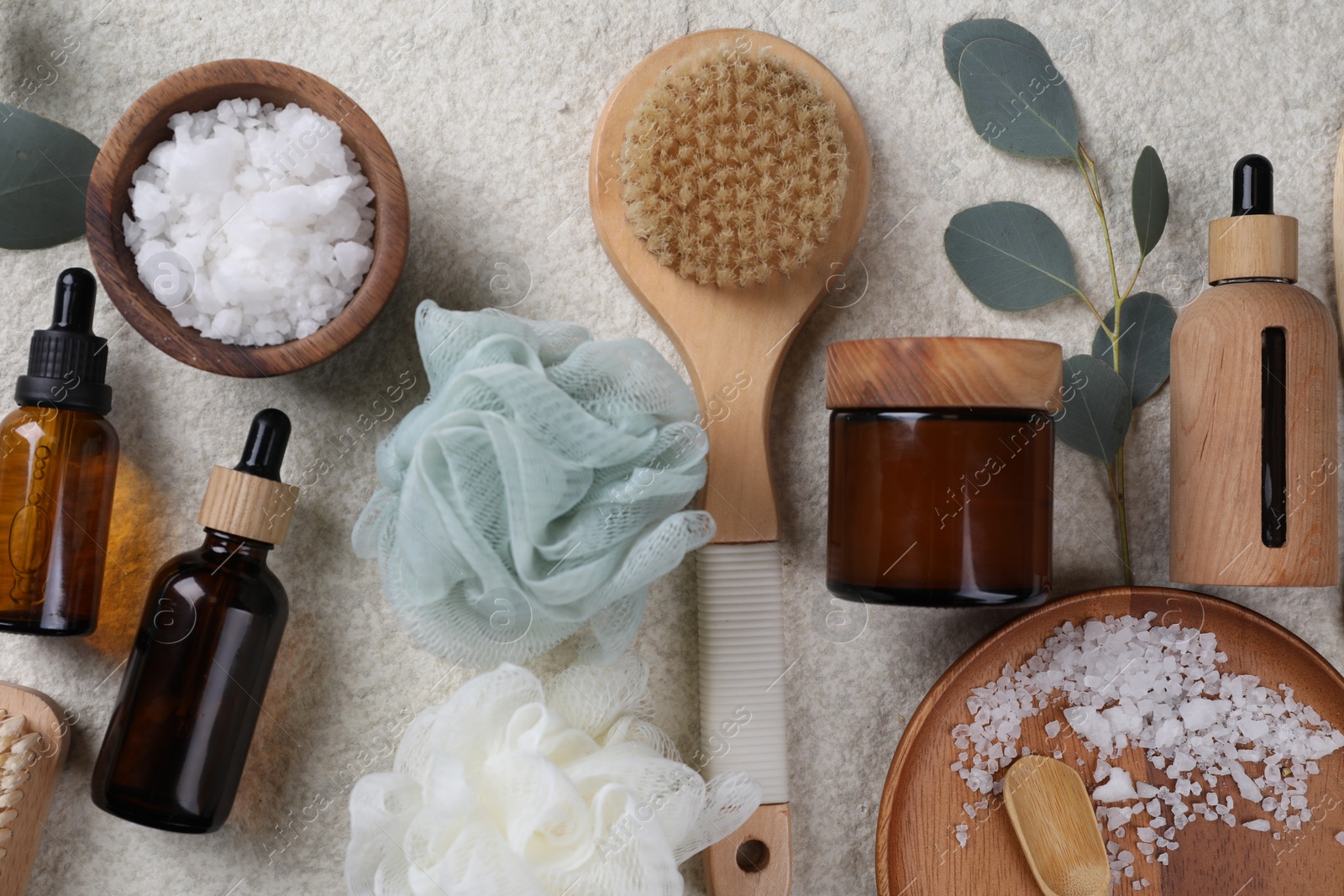 Photo of Flat lay composition with different spa products and eucalyptus branch on light grey textured table