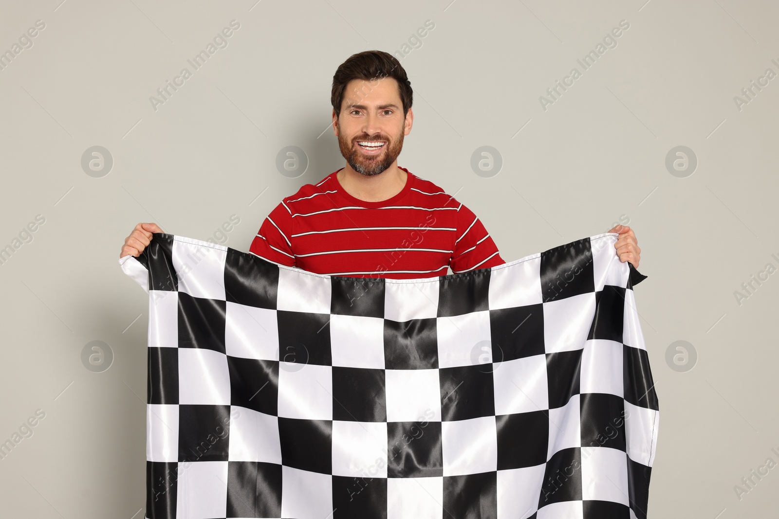 Photo of Man with checkered flag on white background