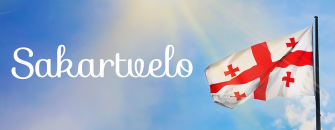 Image of Word Sakartvelo meaning native name of Georgia near its national flag against sky, banner design