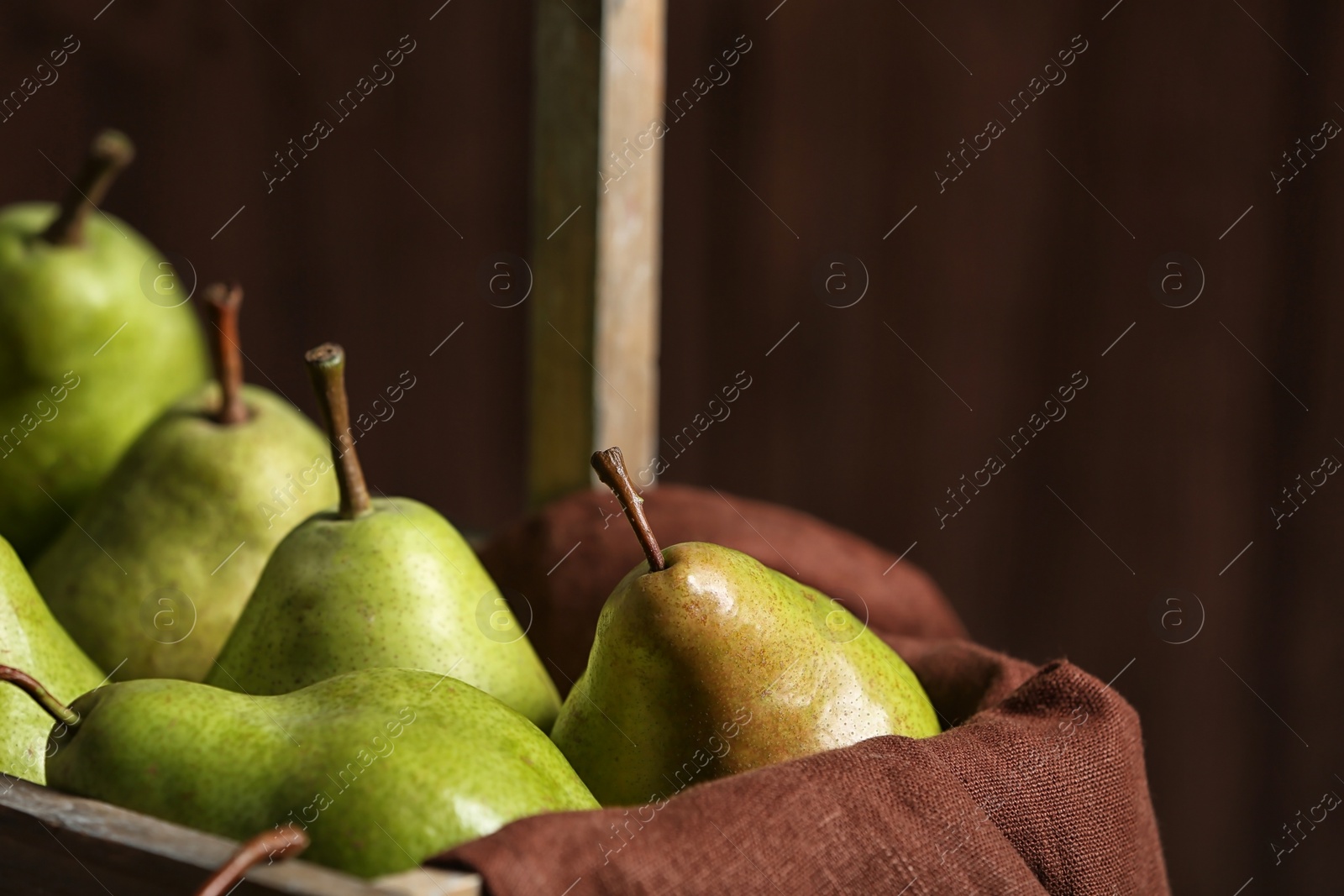 Photo of Tasty ripe green pears in basket, closeup