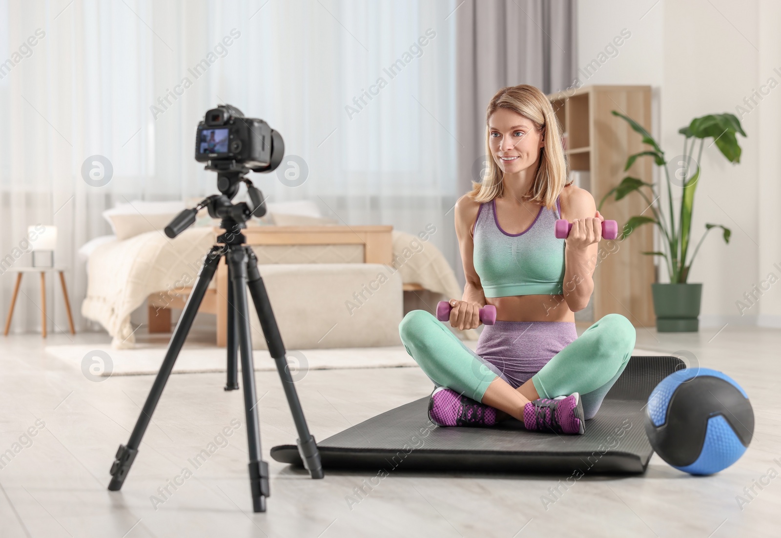 Photo of Fitness trainer recording online classes at home