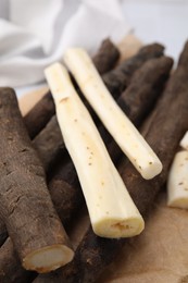 Photo of Raw salsify roots on table, closeup view