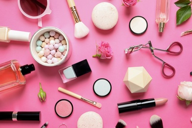 Flat lay composition with products for decorative makeup on pink background