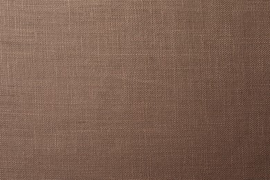 Photo of Texture of brown fabric as background, top view