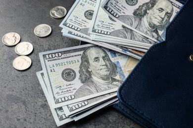 Dollar banknotes, coins and wallet on grey table, closeup. Money exchange