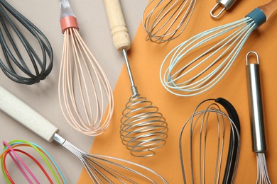 Photo of Different whisks on color background, flat lay