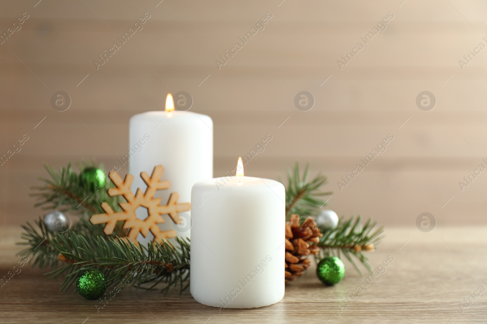 Photo of Beautiful composition with candles and Christmas decor on wooden table
