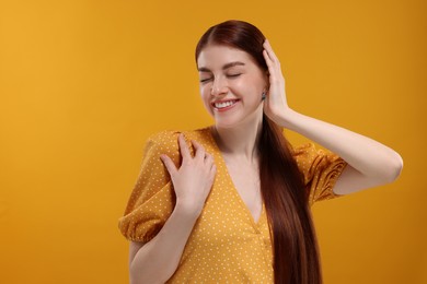 Photo of Portrait of smiling woman on yellow background