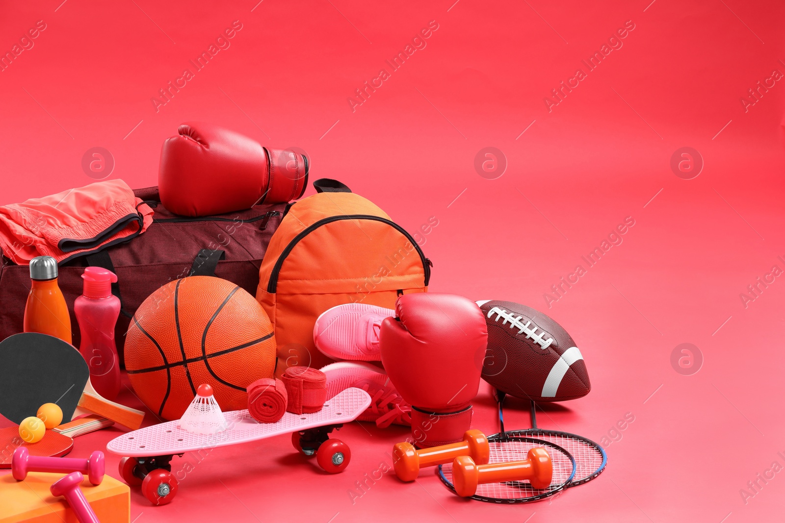 Photo of Many different sports equipment on red background, space for text