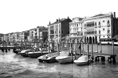 Image of VENICE, ITALY - JUNE 13, 2019: View of Grand Canal with different boats at pier. Black and white tone 