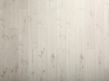 Photo of Light wooden laminate as background, top view. Floor covering