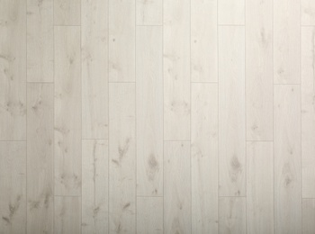 Light wooden laminate as background, top view. Floor covering