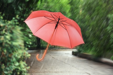 Image of Open umbrella blown by wind gust outdoors