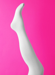 Photo of Leg mannequin in white tights on pink background