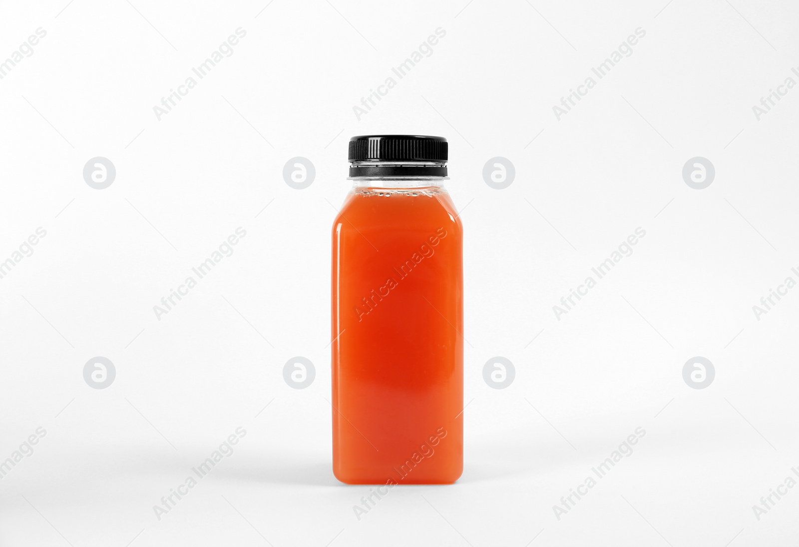 Photo of Bottle with delicious fresh juice on white background