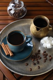 Photo of Turkish coffee. Freshly brewed beverage served on wooden table