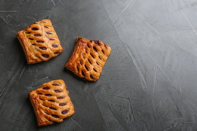 Photo of Fresh delicious puff pastry on grey table, top view. Space for text