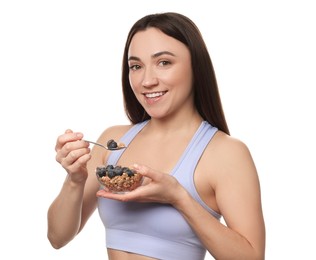 Photo of Happy woman eating tasty granola with fresh berries on white background