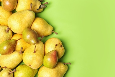 Photo of Flat lay composition with fresh ripe pears and space for text on color background