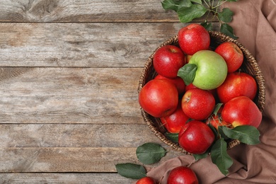 Composition with different apples and space for text on wooden background, top view