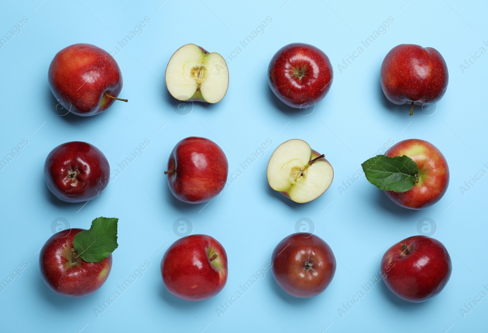 Photo of Tasty red apples on light blue background, flat lay