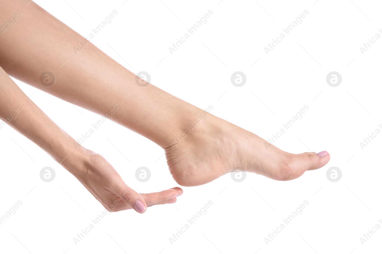 Photo of Woman touching her foot on white background, closeup. Spa treatment